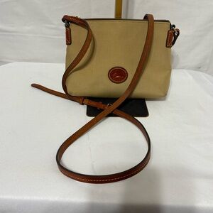 Dooney & Bourke Nylon Crossbody Pouchette bag in a tan with leather trim.
